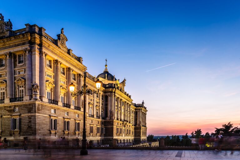 Royal Palace in Madrid, Spain, in a beautiful sunset a summer day. Long exposure people blurred